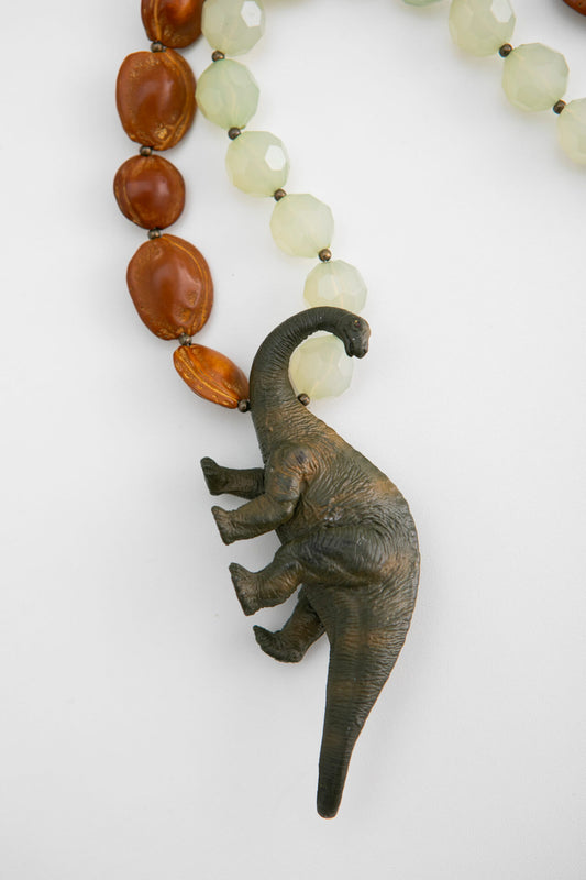 Plastic Dinosaur and Fruit Pit Necklace