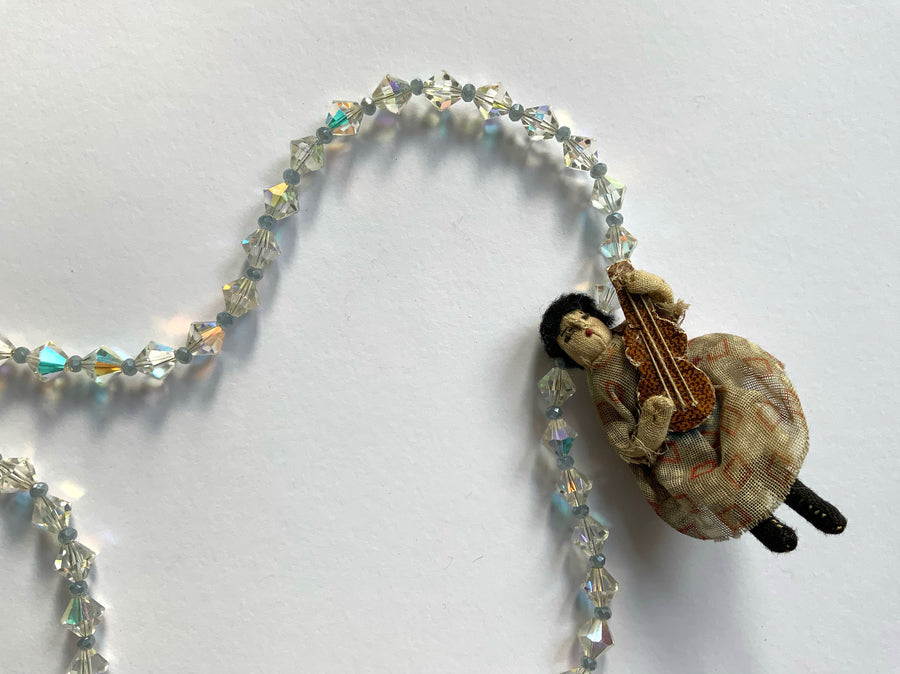Tiny Vintage Doll Playing Guitar on Crystal Necklace
