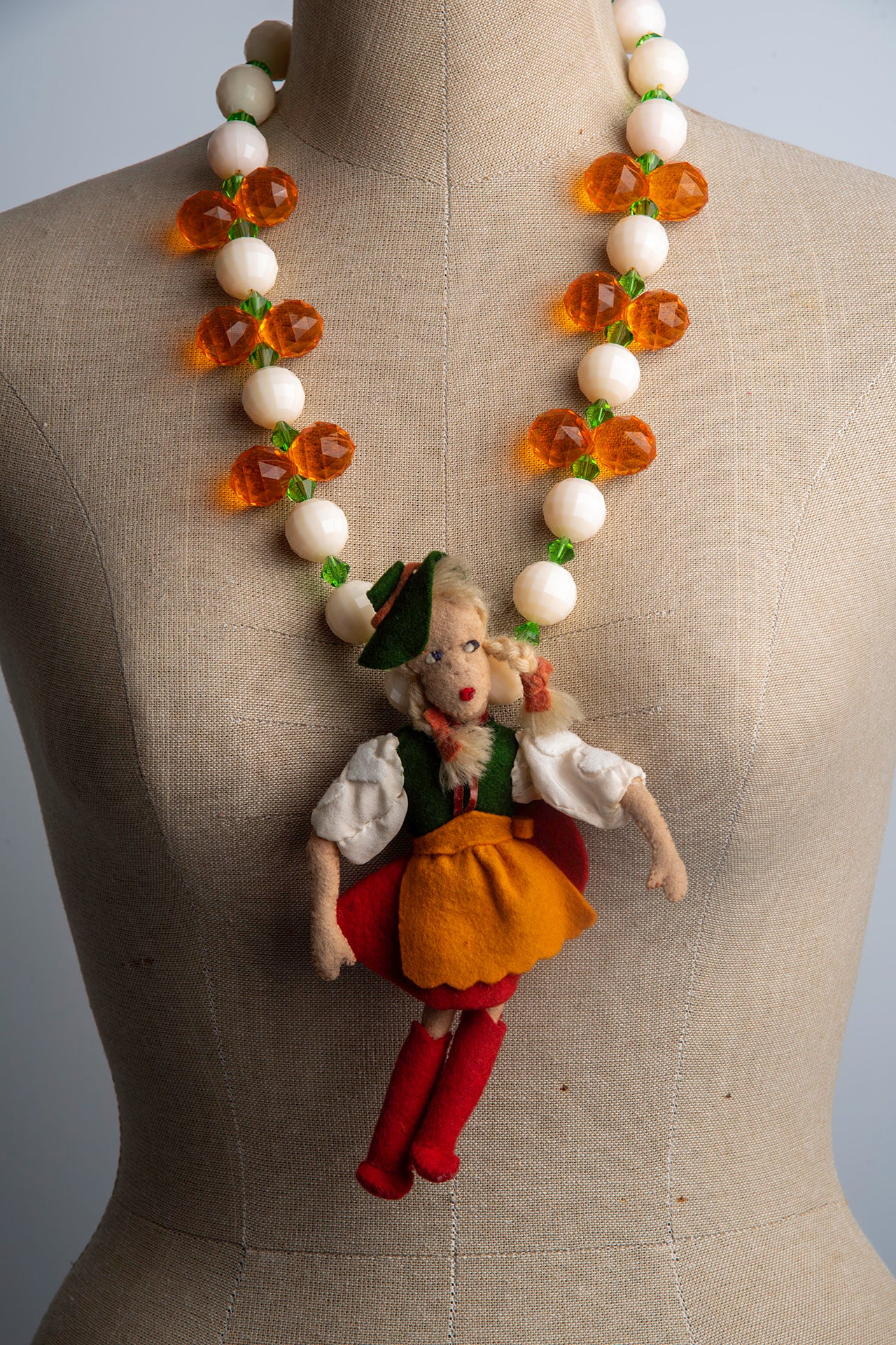 Vintage Doll with Green Hat on Bold Cream and Orange Necklace | Hopetown & Hunter