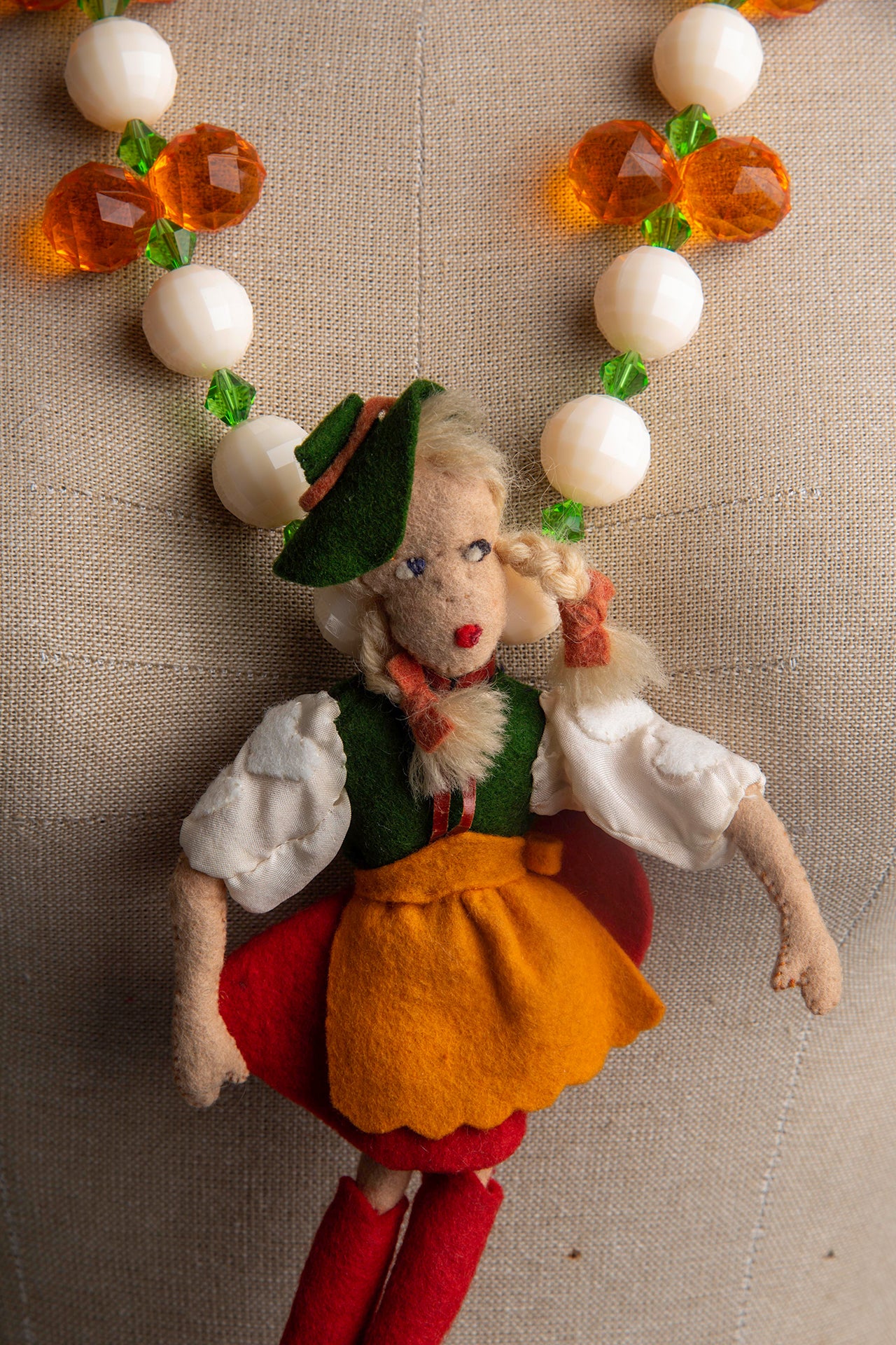 Vintage Doll with Green Hat on Bold Cream and Orange Necklace | Hopetown & Hunter