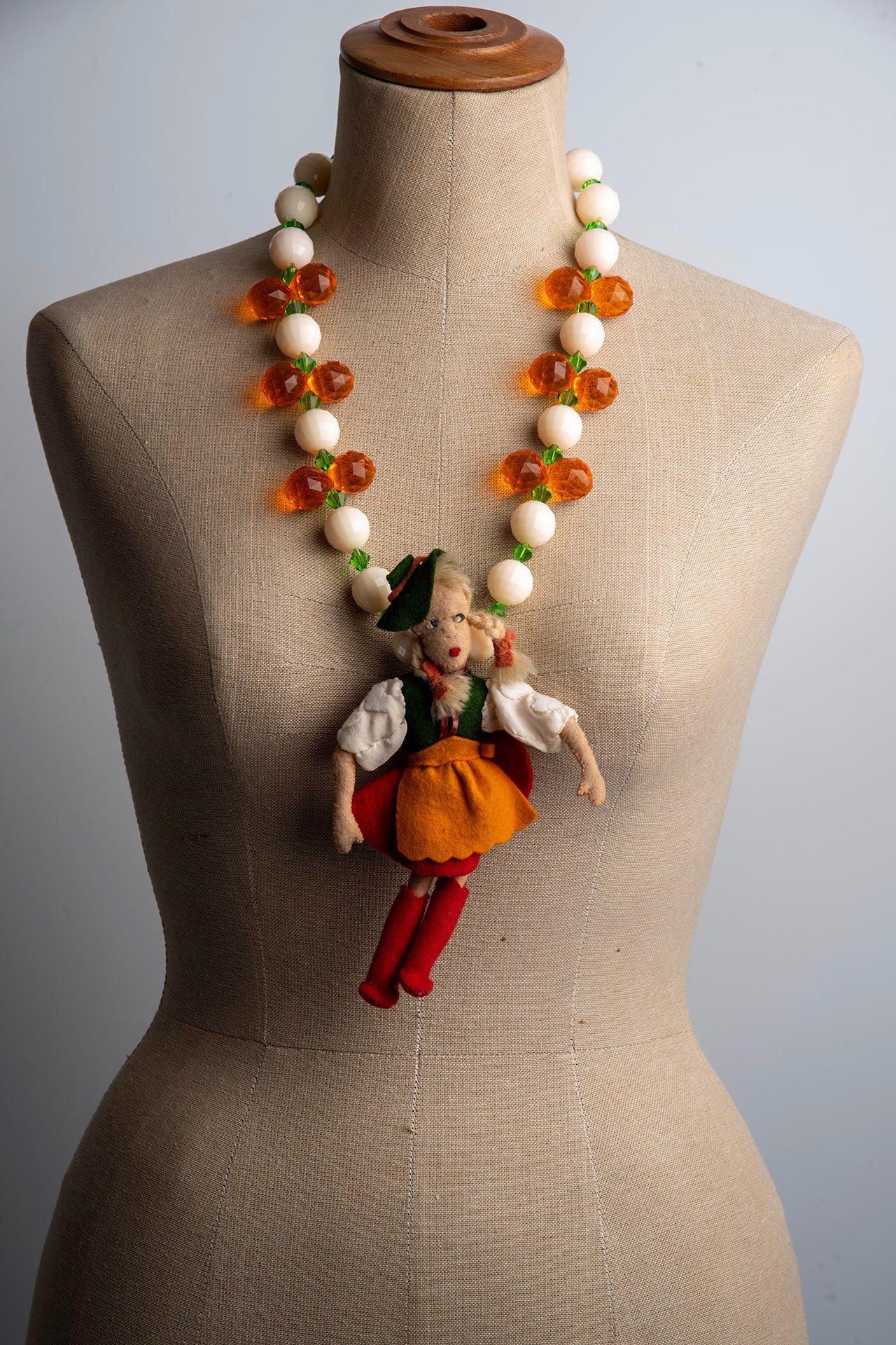 Vintage Doll with Green Hat on Bold Cream and Orange Necklace | Hopeptown & Hunter